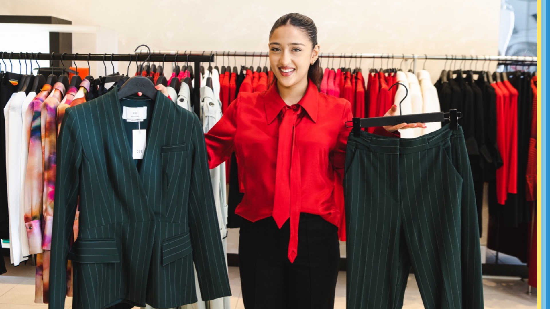 Women holding up an interview outfit option at a store.