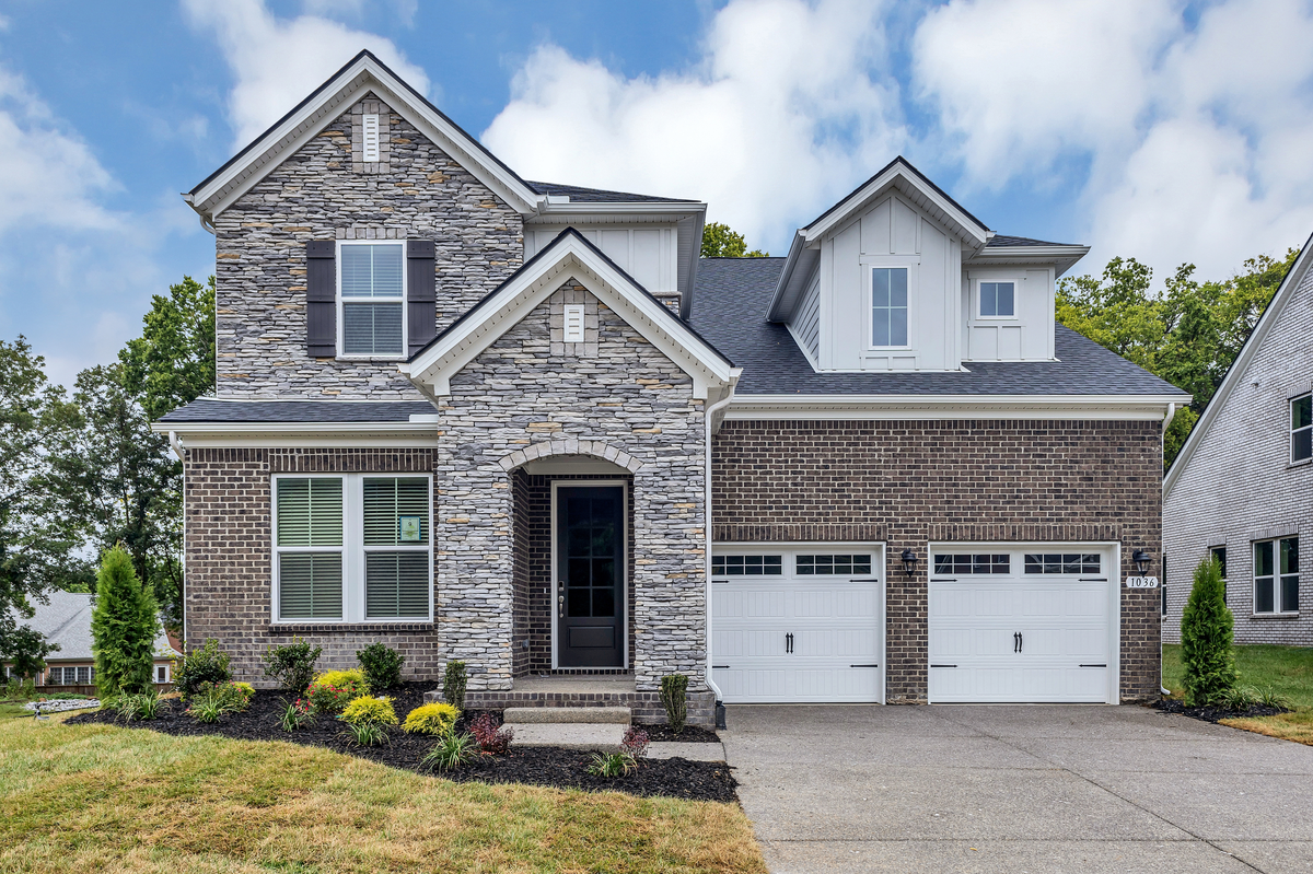 brick and stone exterior with double-bay garage