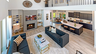 great room with wood flooring, two-story ceiling, and a fireplace