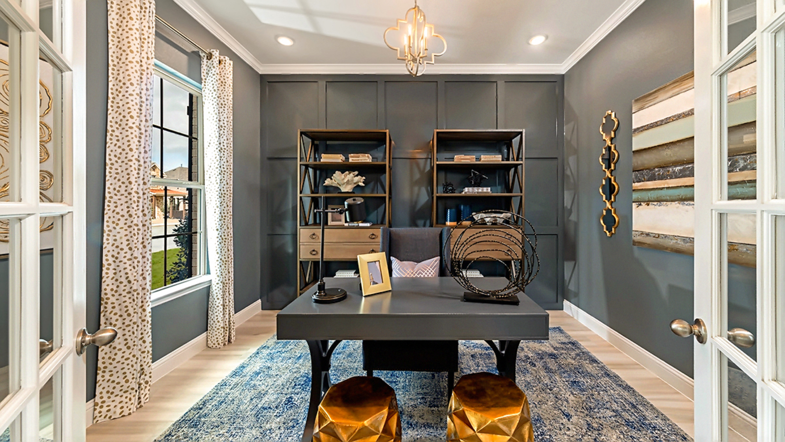 study with accent wall, wood flooring, large windows, and french glass doors