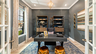 study with accent wall, wood flooring, large windows, and french glass doors