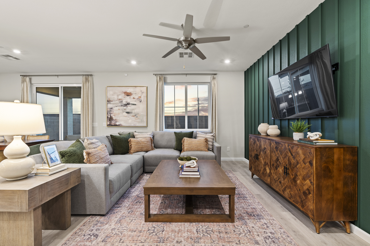 living room with couch and green accent wall