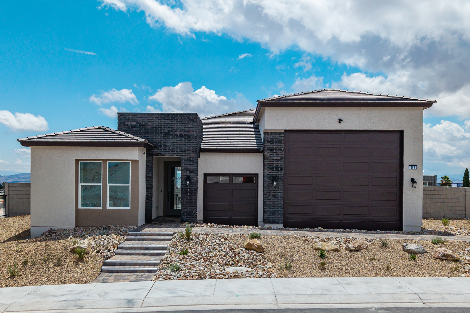 single-story home with brick pavers and rv garage 