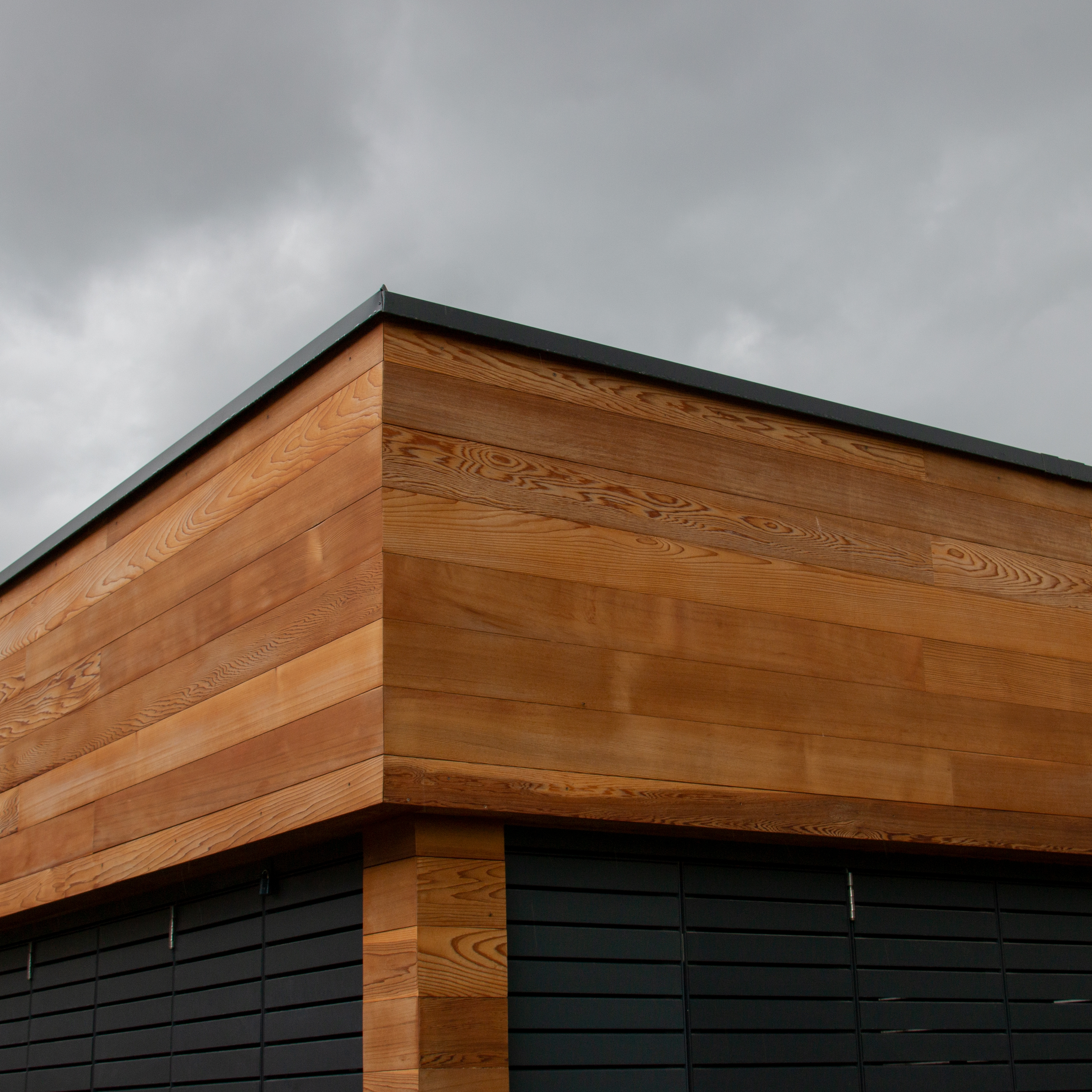 Yukari hardwood boards installed side by side on an exterior wall, showing consistent tone and low knot frequency between boards