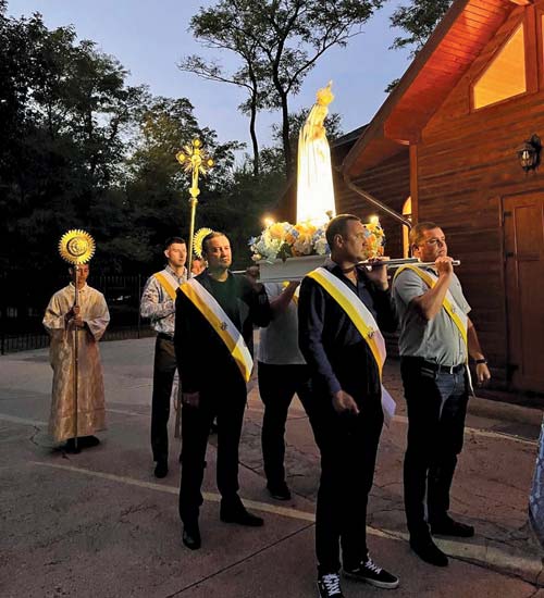 Knights from St. Volodymyr Council 18319 in Zaporizhzhia, Ukraine, carry a statue of Our Lady of Fatima during a prayer vigil at St. Volodymyr Parish on Oct. 31, 2023. Father Bohomaz brought the statue to about 30 parishes in eastern Ukraine as part of an evangelization mission in which he emphasized Marian devotion and the rosary. (Photo courtesy of Father Oleksandr Bohomaz)