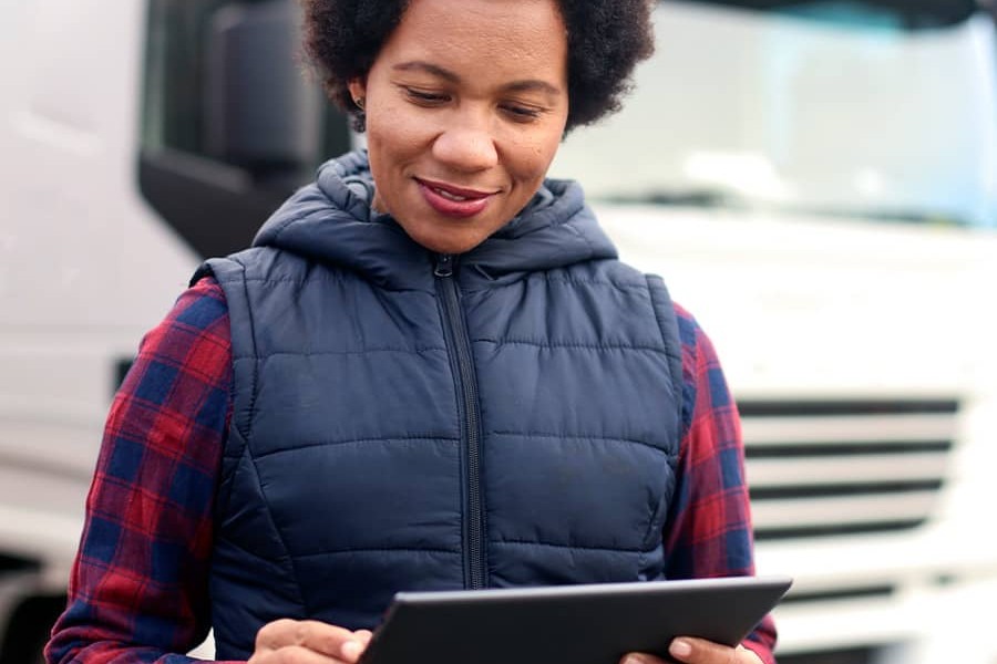 Female looking at an iPad outside by a truck