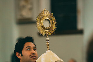 Priest leads a eucharistic procession