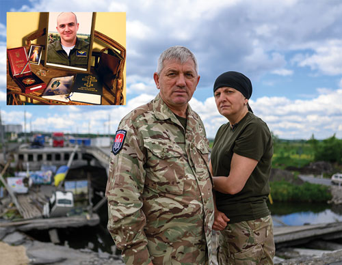 Ivan and Olena Dovzhinsky stand at the site of a bridge between Irpin and Kyiv destroyed in the early days of the war