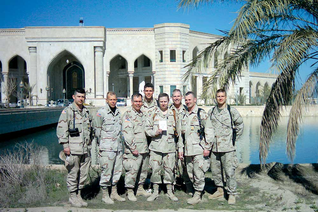 U.S. Army Maj. Michael Ricky, holding a copy of Armed with the Faith, stands with other service members outside Baghdad’s Al Faw Palace on Feb. 8, 2004.