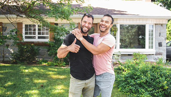 couple smiling together outside their home