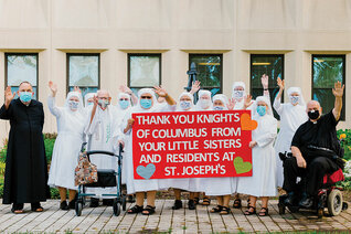 Sisters and several priest residents at the St. Joseph’s Home in Palatine, Ill., express their thanks to the Knights of Holy Ghost Council 4977.