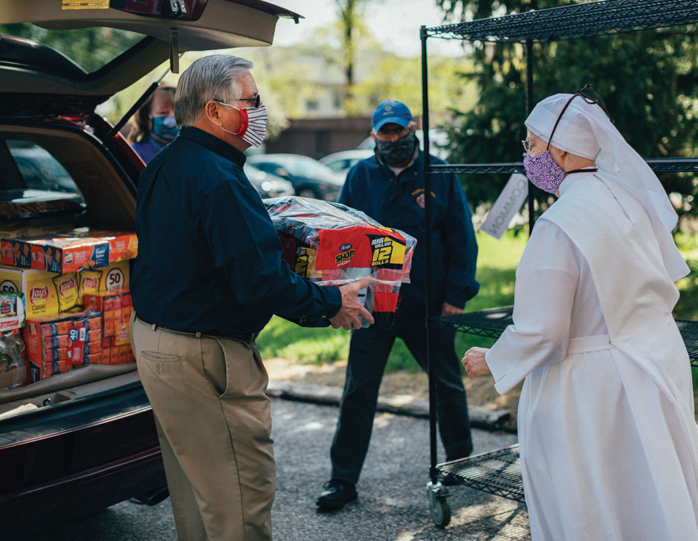 Maryland State Deputy Dale Trott helps unload a delivery of supplies at St. Martin&rsquo;s Home in Catonsville, Md.