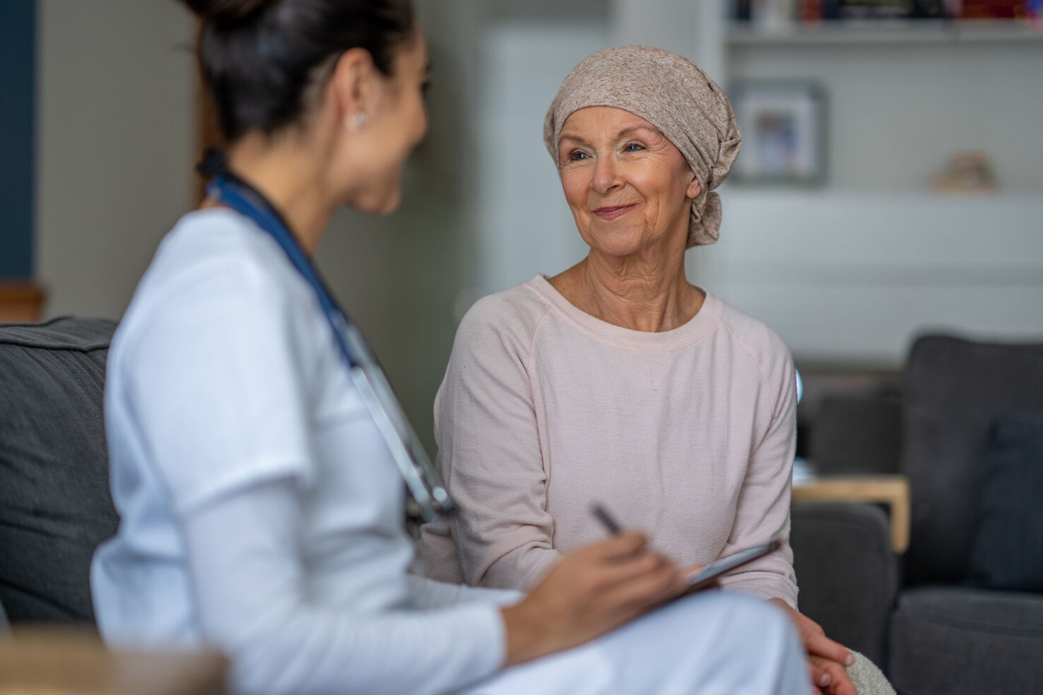 Patient with headscarf consults doctor about triple negative breast cancer surgery