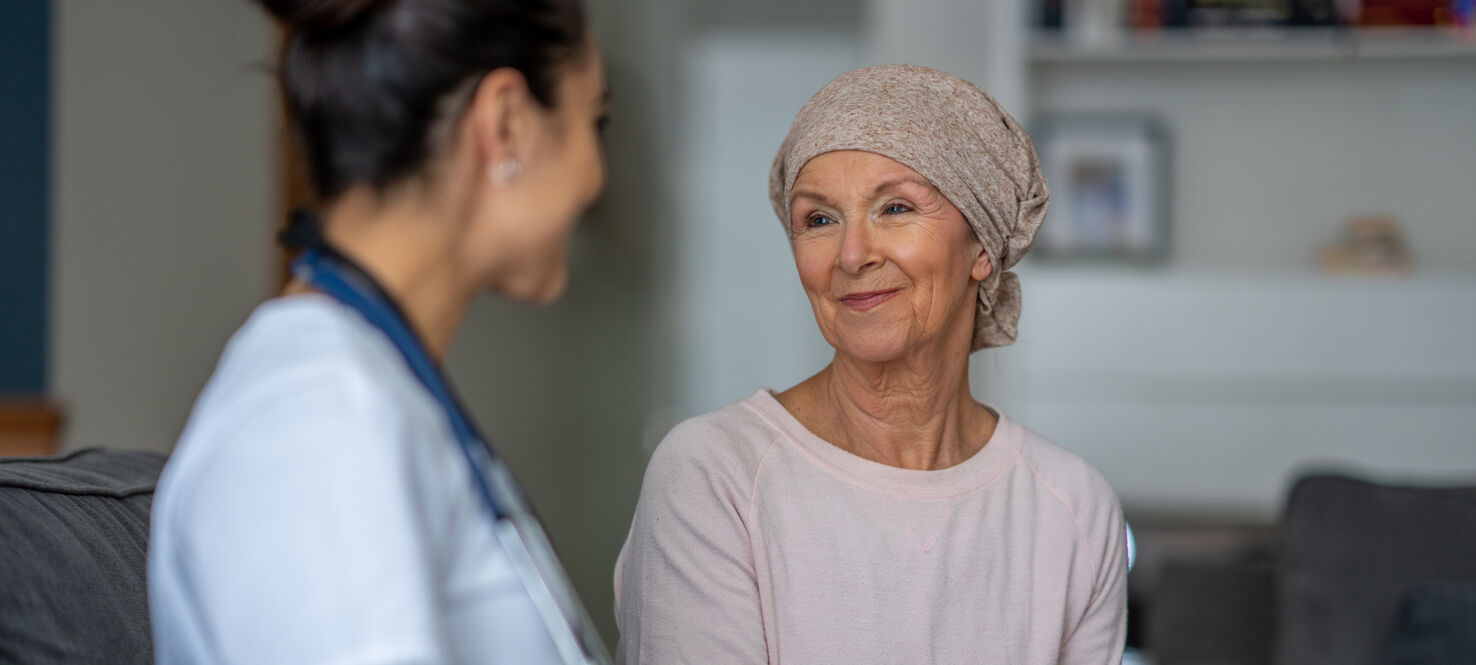 Patient with headscarf consults doctor about triple negative breast cancer surgery