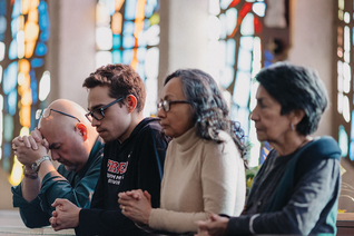 Matthew prays with his parents