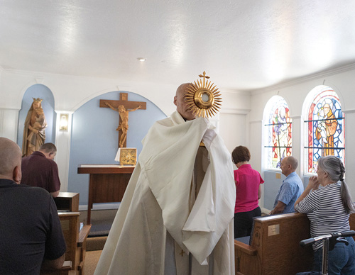 Father Santiago Iriarte, pastor of St. Ann Parish in Ridgefield, Calif., carries the Eucharist following Benediction at the parish&rsquo;s Blessed Sacrament chapel May 9. The chapel was recently renovated with financial support from Father John Crowley Council 3199, for which Father Iriarte serves as chaplain. (Photo by Christine Bartolucci)