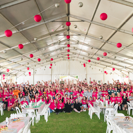 Volunteers at Christmas Lunch in the Park smiling in a group photo.