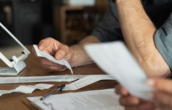 Professionals sitting at a desk filling out an expense report