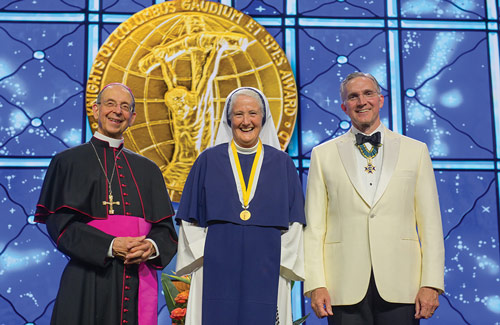 Mother Agnes Mary Donovan of the Sisters of Life stands with Supreme Knight Kelly and Archbishop Lori after receiving the Gaudium et Spes Award at the States Dinner