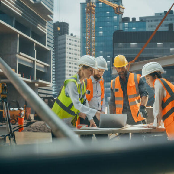 Female engineers working on laptop at job site