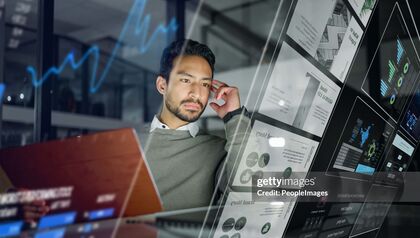 Businessman looking at digital interfaces