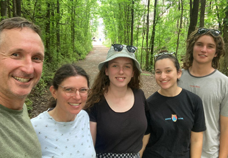 Phil Chapman smiling with his family on a wooded trail, representing a legacy of compassion through a gift in his Will to Mission Australia.