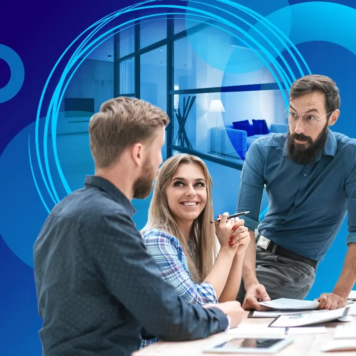 Three colleagues having a discussion at a desk in a modern office setting, with a blue abstract background.