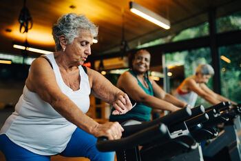 women on stationary bikes at the gym
