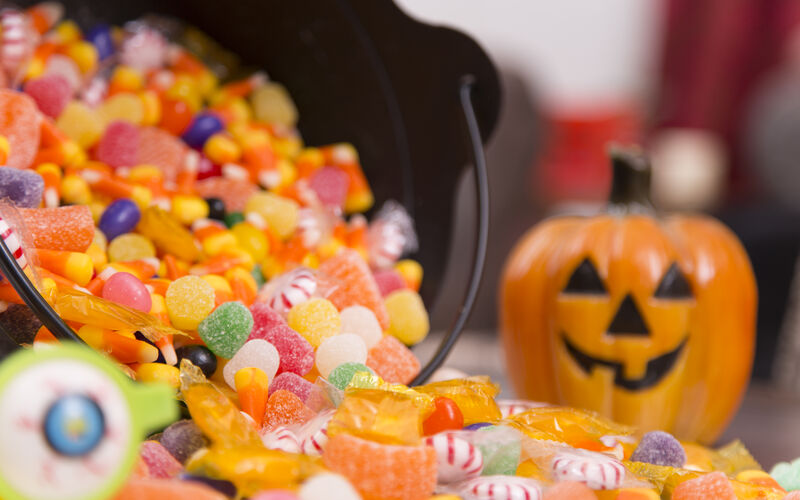 Halloween candy on a table with a pumpkin