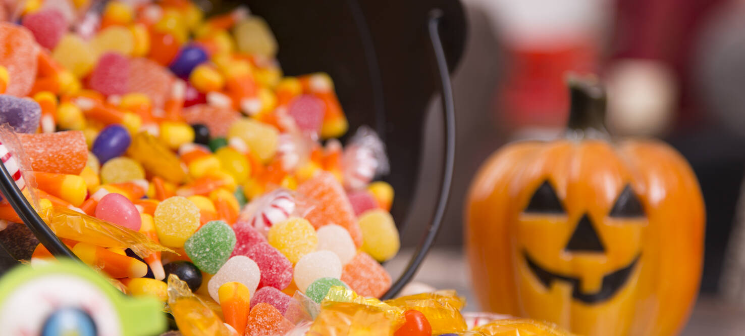 Halloween candy on a table with a pumpkin