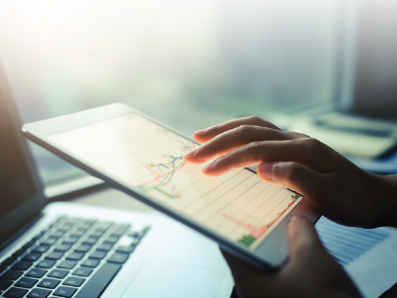 a person interacting with a graph on a digital tablet