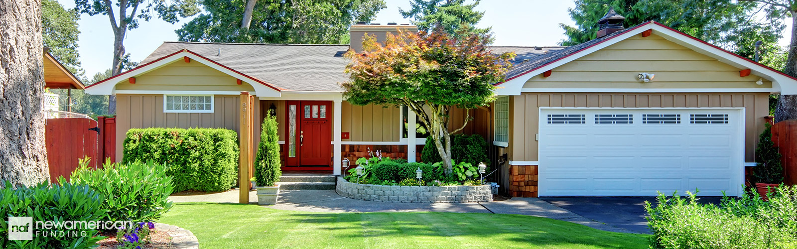 A nice wood and vinyl house with dark yellow walls, red trim, and a bright red door