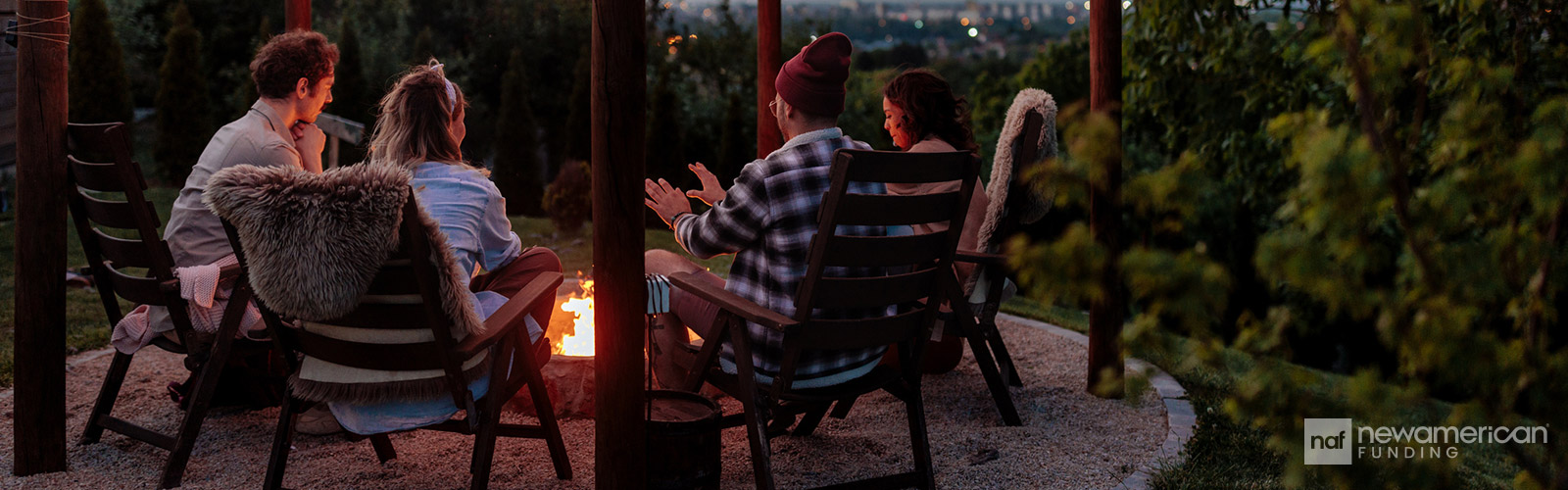 friends sitting around a firepit at night