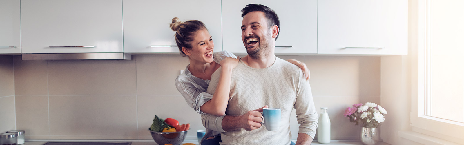 couple laughing in the kitchen