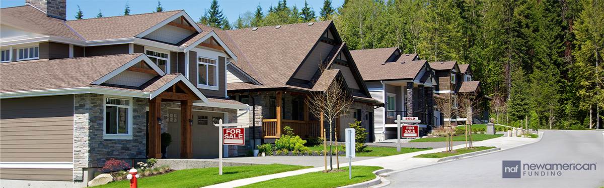 row of houses with two for sale signs