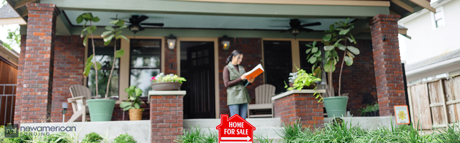 woman going over details in front a house for sale