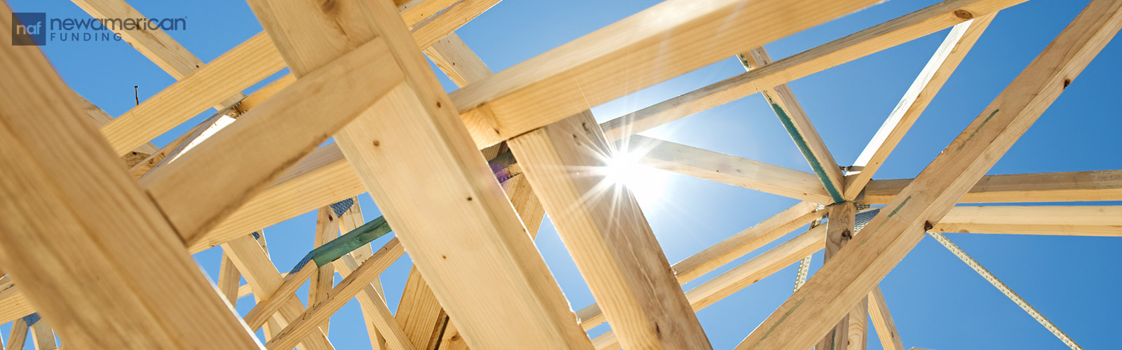 the sun shines through the spaces in a wooden house frame