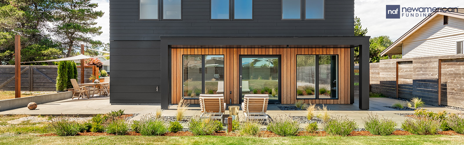 a black modern home with a secondary building beside it