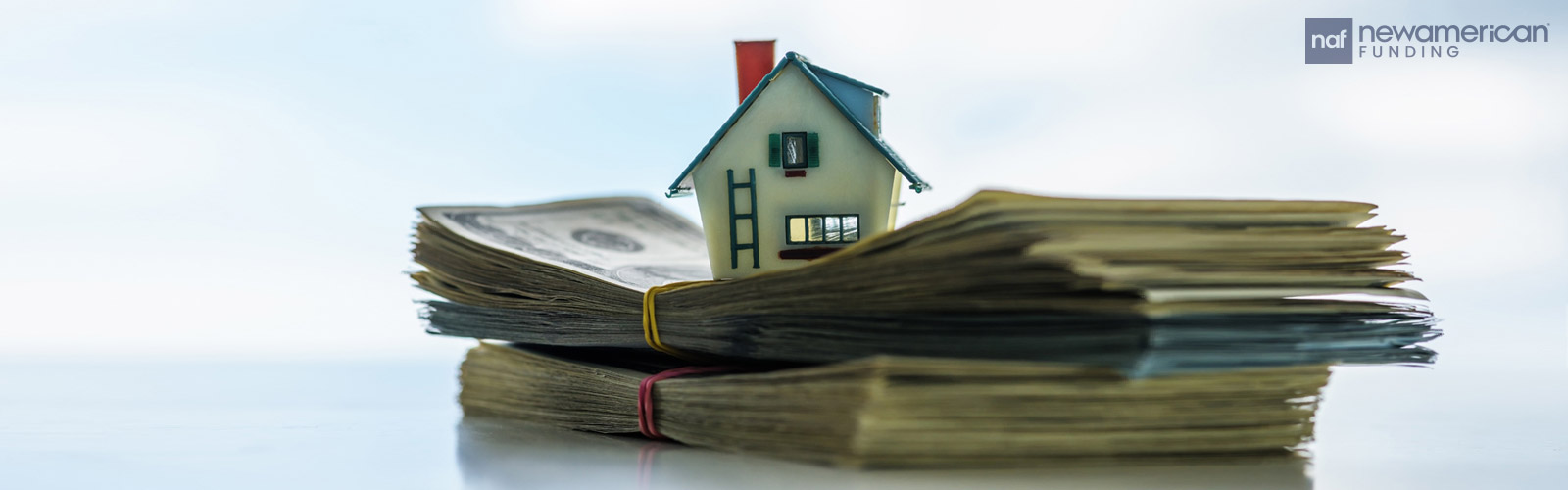 house model on stack of cash