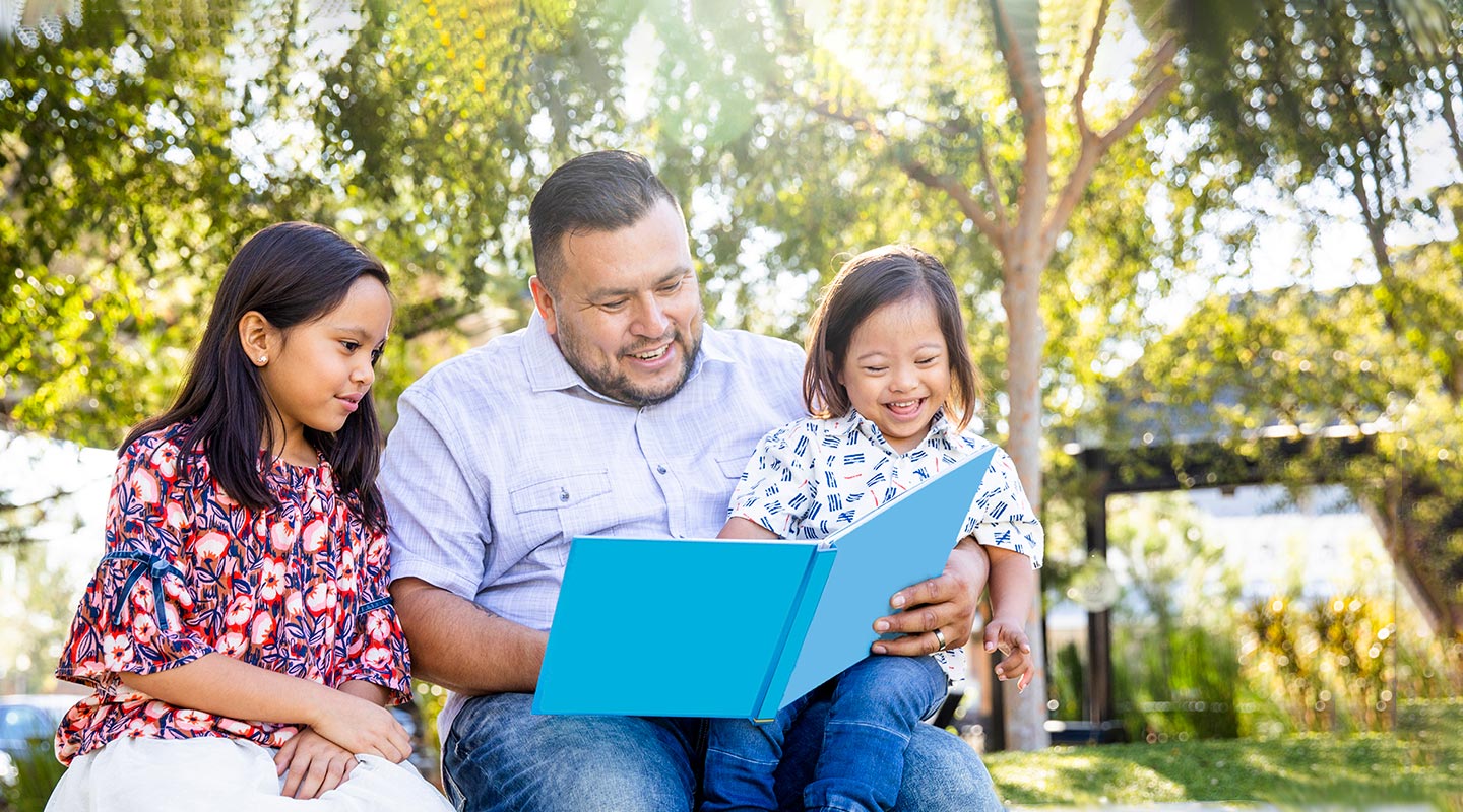 hero-dad-reading-to-son-daughter-outside-j9122.jpg