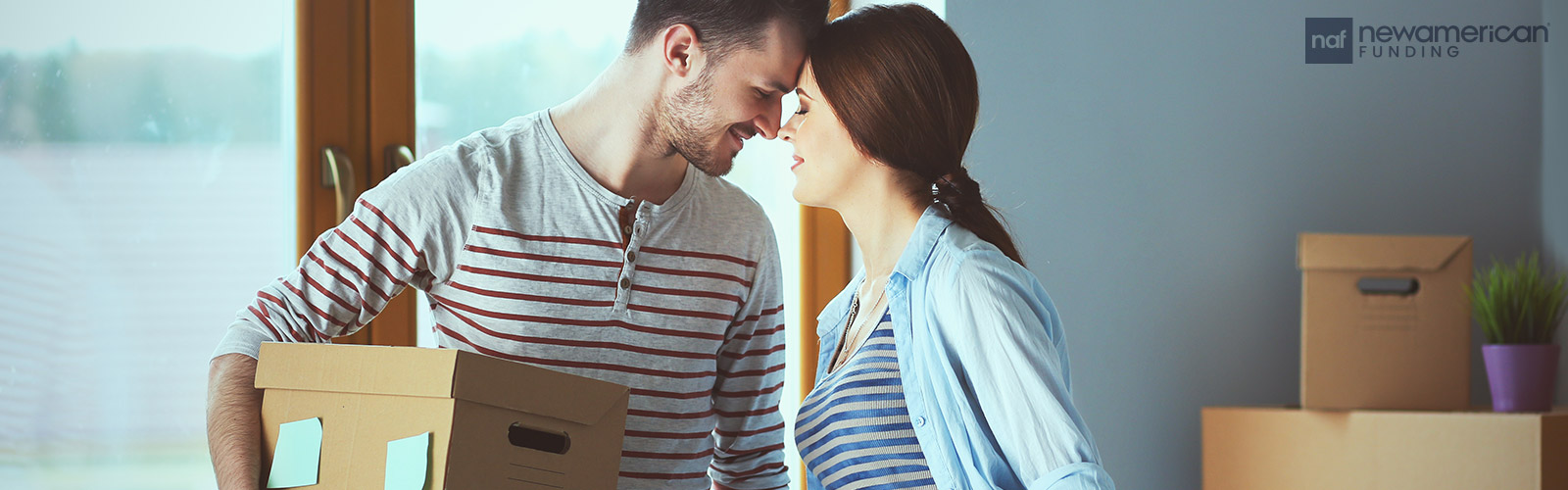 couple sharing a moment while moving into their new home