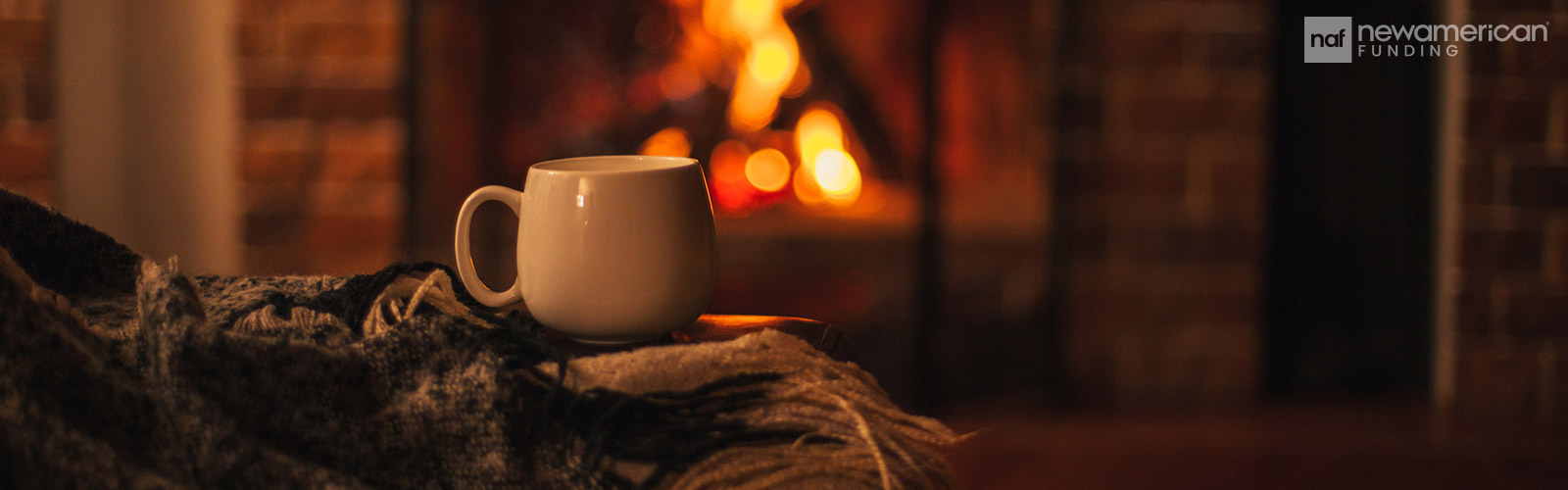 hot drink in front of the fireplace with a blanket