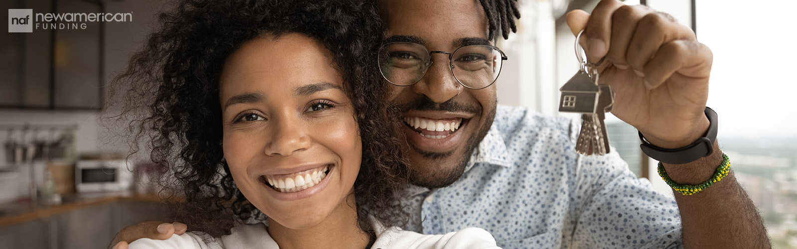 happy Black couple holding house keys