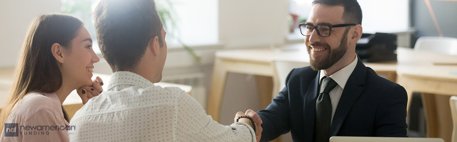 agent shaking hands with clients