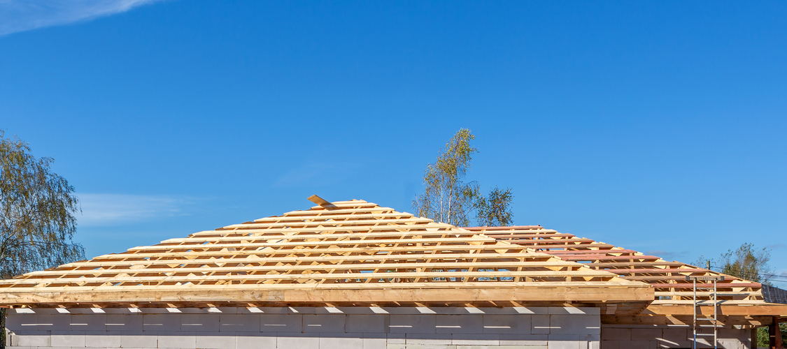 A framed roof of a home under construction.