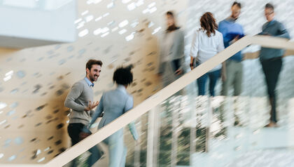 Large group of business people in blurred motion in a hallway