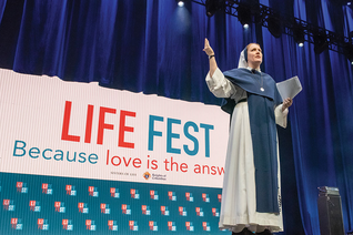 Sister Bethany Madonna of the Sisters of Life welcomes a crowd of several thousand young people to Life Fest.