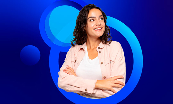 A young woman with dark, curly hair smiles and looks up and to the right, standing with her arms crossed. She is wearing a light pink jacket over a white shirt. The background is a bright blue with faint concentric blue circles.
