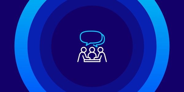An abstract graphic featuring a dark blue background with concentric, expanding circles in varying shades of blue. In the center, there is a white and light blue line icon depicting three people sitting at a table with speech bubbles above them, symbolizing a meeting or discussion.
