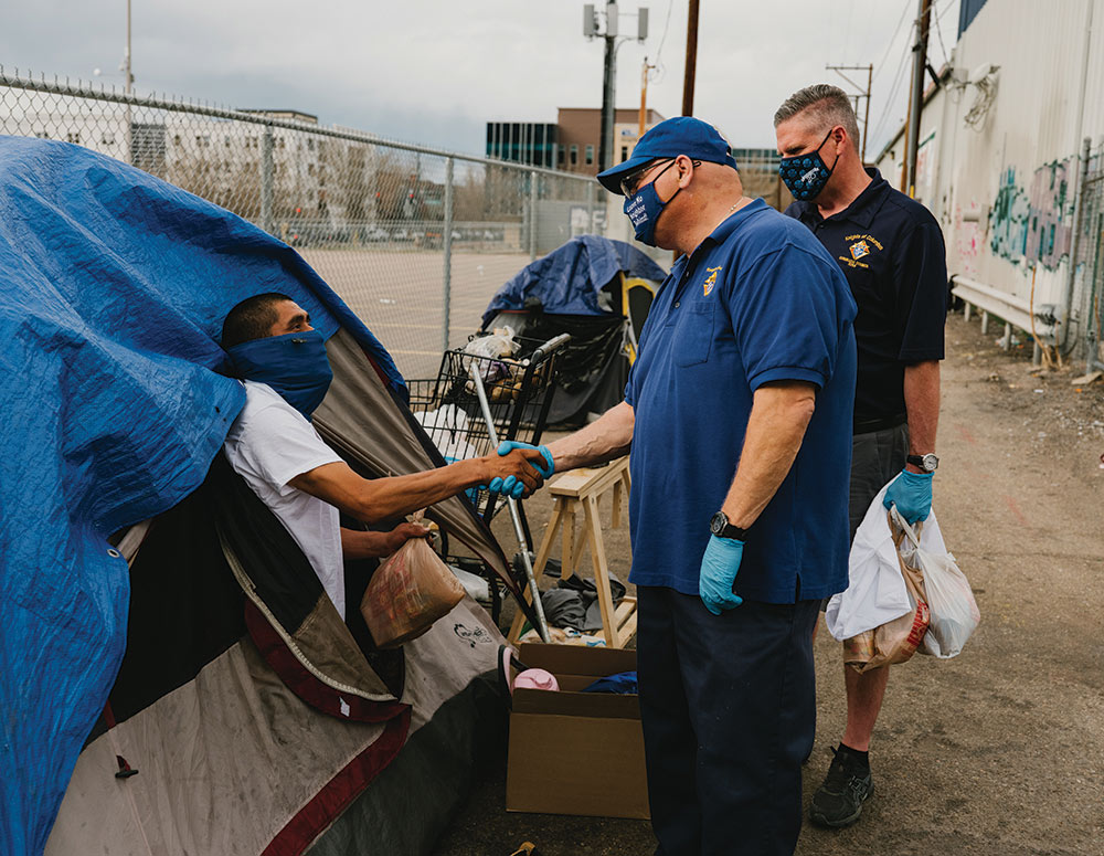 Lubrano gives a blanket and food to a young man in February.